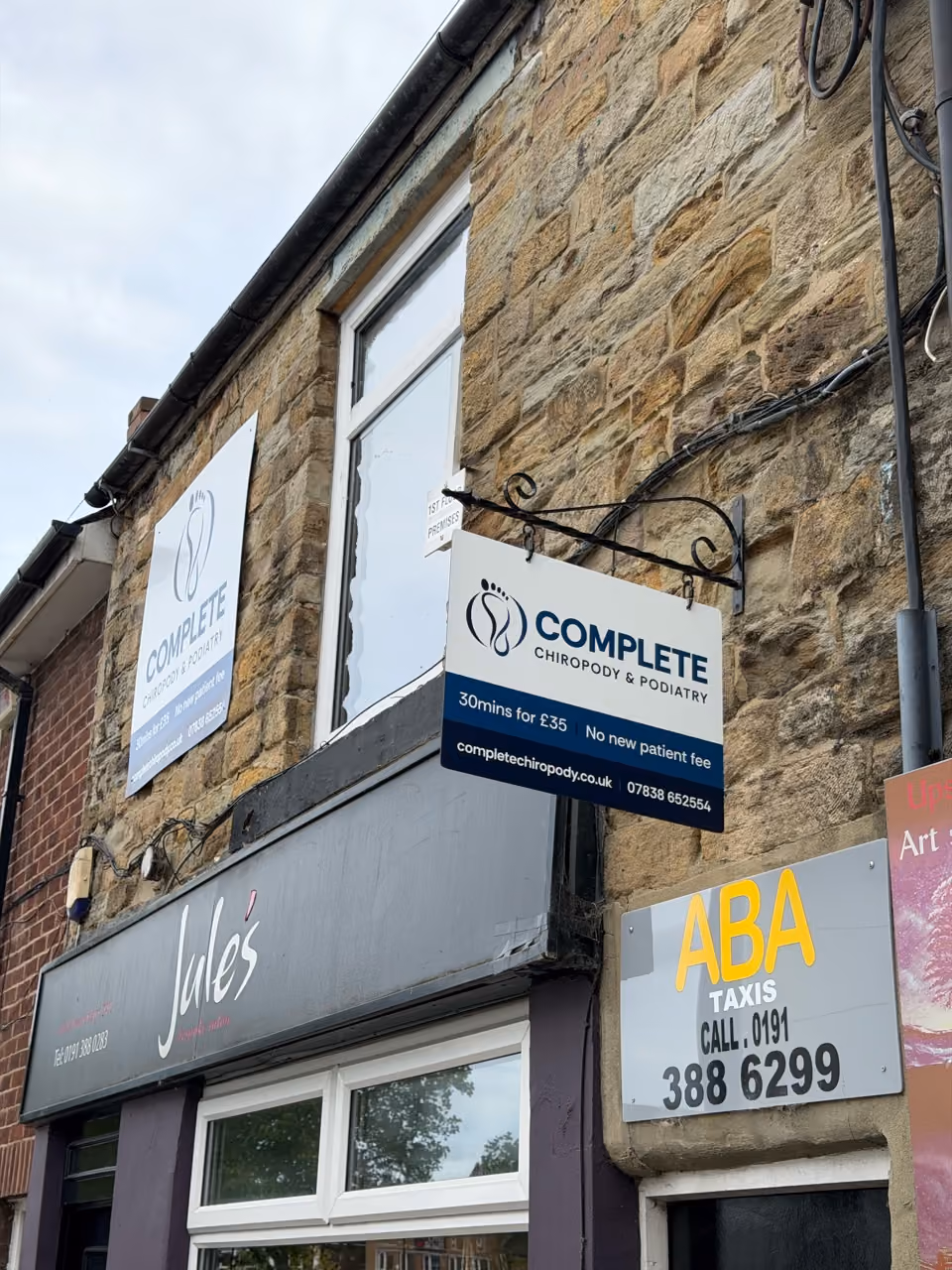 The frontage of a small foot-care clinic on a quiet high street